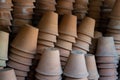 Closeup of stacks of old used weathered terra cotta flower pots in gardening shed Royalty Free Stock Photo