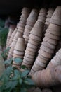 Closeup of stacks of old used weathered terra cotta flower pots in gardening shed Royalty Free Stock Photo