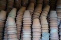 Closeup of stacks of old used weathered terra cotta flower pots in gardening shed