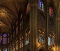 Closeup of stained glass windows and arched cloister and ceiling in the Notre Dame de Paris Cathedral in Paris France