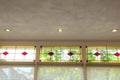 closeup of stained glass windows with red and yellow sections in a cozy beautiful home with a green view Royalty Free Stock Photo