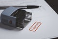 Closeup of stamper with red approve wording on paper for approve document , business project permit and ISO certificate concept Royalty Free Stock Photo