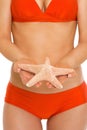 Closeup on starfish in hand of woman in swimsuit Royalty Free Stock Photo