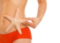 Closeup on starfish in hand of woman in swimsuit Royalty Free Stock Photo
