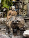 Closeup of a statue of a buddhist monk riding on a bull at the Wat Pho Temple in Bangkok, Thailand