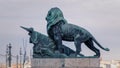 Closeup of a statue of a lion and an arrow on a