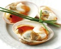 Closeup of clams garnished with chives