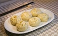 Closeup of steamed meat buns in long plate on the table, homemade gourmet food Royalty Free Stock Photo