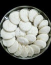 Closeup of steamed rice pancakes in a plate isolated from black vignettes, food photography, Indian cuisine, rice meals