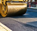 Steamroller compacts asphalt in road repaving project. Royalty Free Stock Photo