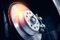 Closeup steel brake disk and detail of wheel hub with sunlight. Concept replacing wheel pads in garage car service Royalty Free Stock Photo