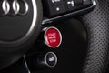 Closeup of Steering wheel start stop button of Red Audi R8 Sport Plus