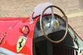 Closeup of the steering wheel of a vintage Ferrari racing car.