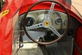 Closeup of the steering wheel of a vintage Ferrari racing car.