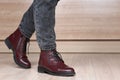 Closeup of stepping woman legs in red leather boots and black jeans Royalty Free Stock Photo