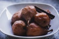 Closeup of stewed pears poached in red wine and served on a white bowl