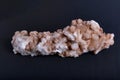 Closeup of a stilbite mineral piece on the dark blurred background