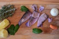 Raw squid, basil, rosemary, potatoes and vegetables at wooden background/ top view/ closeup