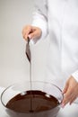 Closeup stirring pouring dark melted bitter unsweetened hand-crafted chocolate Royalty Free Stock Photo