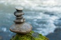 Stone balance on rock covered by moss in border river Royalty Free Stock Photo