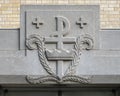 Closeup of stone carving above the side entrance to the narthex on the North side of Christ the King Church in Dallas, Texas.