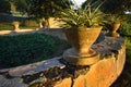 Closeup of stone flower pots set in a circle in a garden