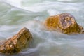 Stones among emerald rushing mountain river Royalty Free Stock Photo