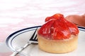 Closeup strawberry custard glazed tart with a fork