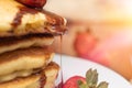 Closeup of a strawberry dripping chocolate syrup