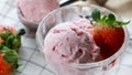 Closeup Strawberry ice cream in the glass cup with strawberry fruits background. Desserts summer season concept