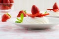 Closeup strawberry meringue nest on a white plate