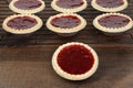 Closeup strawberry tart more cooling in background