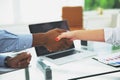 Closeup.strong financial partners shaking hands over a Desk