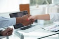 Closeup.strong financial partners shaking hands over a Desk