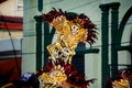 Closeup strong man carries scary demon mask by city street at dominican carnival