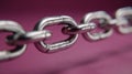 Closeup of a strong metal chain on a pink background Royalty Free Stock Photo