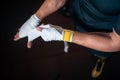 Close up of boxer man bandage hand and preparing for training or fighting in gym