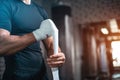 Close up of boxer man bandage hand and preparing for training or fighting in gym