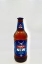 A closeup of a stubby of Tooheys New against a white background
