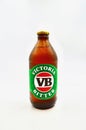 A closeup of a stubby of Victoria Bitter against a white background