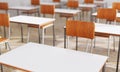 Closeup student chair seat and desk in classroom background with on wooden floor. Education and Back to school concept.