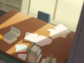 A closeup of a students desk filled with books and papers looking lopsided and dwarfed by the desks next to it.. AI