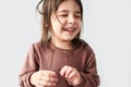 Closeup studio horizontal portrait of happy cute little girl smiling joyful and wearing sweater isolated on a white studio Royalty Free Stock Photo