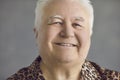 Closeup studio portrait of a cheerful senior man smiling and looking at the camera Royalty Free Stock Photo