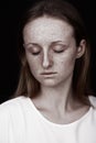 Closeup studio portrait of freckled woman without makeup