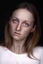 Closeup studio portrait of freckled woman without makeup