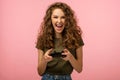 Closeup studio portrait of pretty gamer girl with gamepad