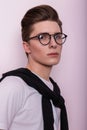 Closeup studio portrait of a young trendy man hipster with clean skin with nose piercings in a vintage white t-shirt on a pink Royalty Free Stock Photo