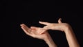 Closeup studio shot of beautiful caucasian woman showing open palm and touching it with hand.