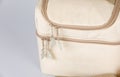 Closeup studio shot of cream and beige color multifunction multipurpose utility compartments zipper newborn baby toddler mommy bag